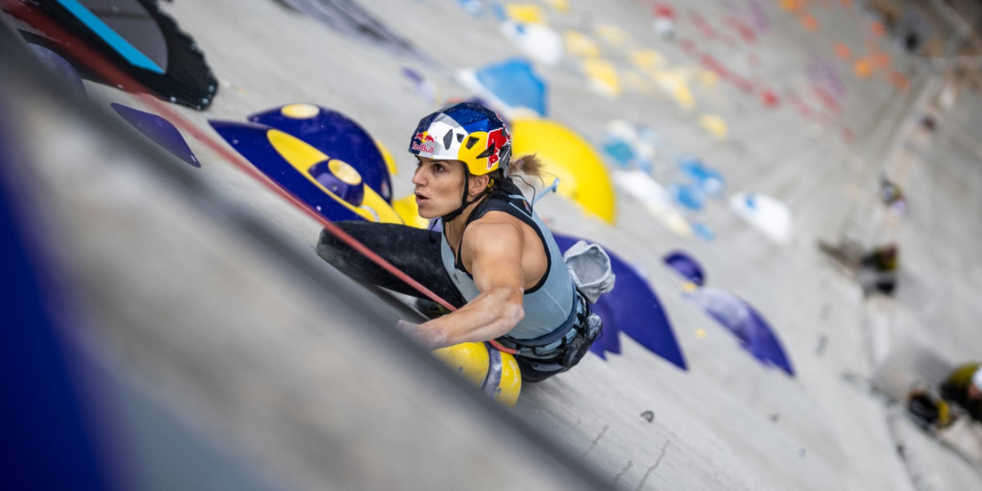 Athletin Petra Klingler ist in einer Nahaufnahme zu sehen, während sie die Staumauer erklimmt.
